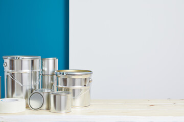 Brushes for painting with paint and cans on a workshop table. Painting accessories prepared for painting.