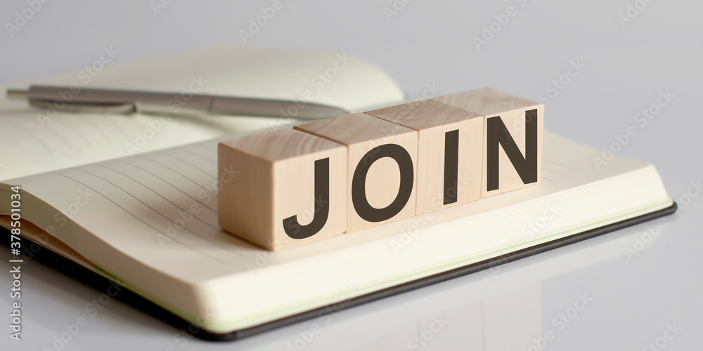 Poster the join sign on a wooden block on notebook background