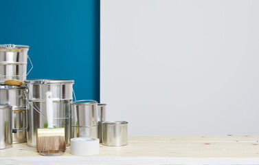 Brushes for painting with paint and cans on a workshop table. Painting accessories prepared for...