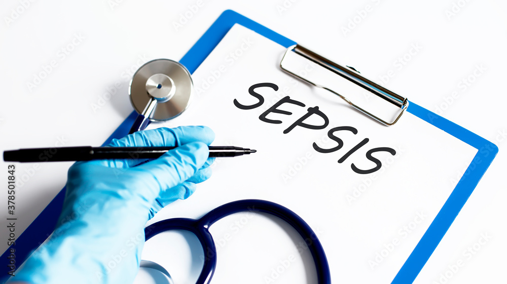 Poster paper with text sepsis on a table with stethoscope
