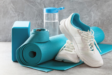 Yoga or fitness items- mat, block, sneakers