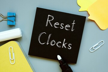 Financial concept meaning Reset Clocks with phrase on the sheet.