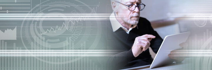 Senior man using his tablet; panoramic banner