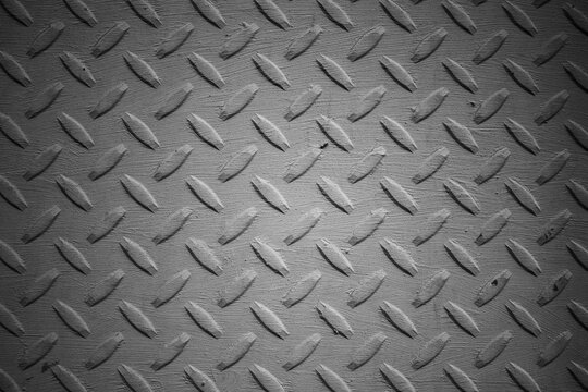 evocative black and white image of metal plate texture with abstract relief patterns