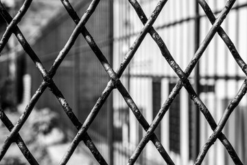 Fototapeta premium black and white texture of trapeze shaped iron grate of a gate
