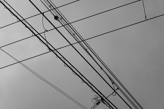 Cable car lines below overcast sky
