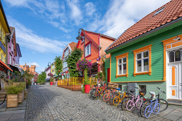 Stavanger, Norway - View of the old town streets, people and restaurants in Stavanger, Norway. Stavanger is one of most famous cruise travel destinations in Europe. - obrazy, fototapety, plakaty
