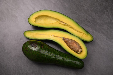Long avocado on black table. Healthy breakfast and Vegetarian food