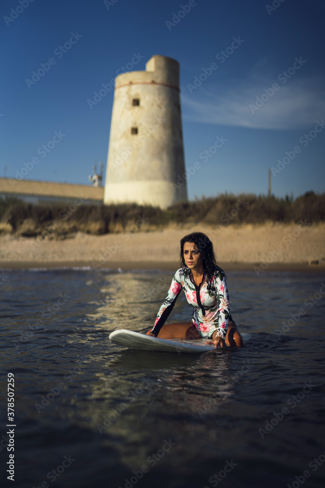 Sticker Vertical shot of a caucasian woman surfing