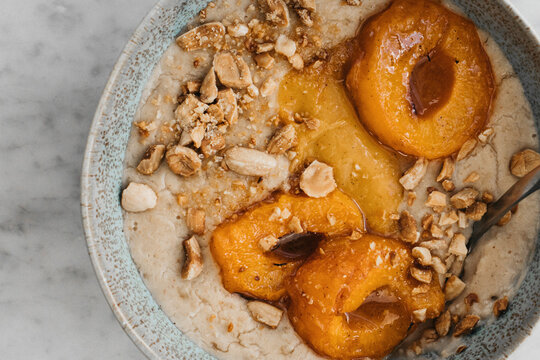 Roasted apricot porridge with almond milk and nuts

