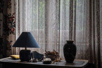 different objects on a dresser and curtain on the windows