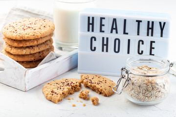 Oatmeal and red quinoa cookies with milk, light board on background, horizontal