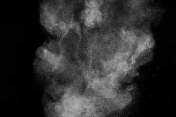 Freeze motion of white particles on black background. Powder explosion. Abstract dust overlay...