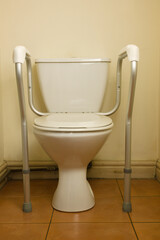 Domestic toilet frame for disabled user,  improves the safety of elderly and disabled users when they use the toilet