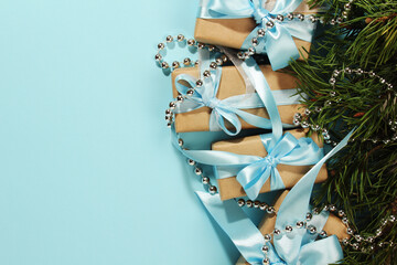 Gift boxes wrapped in craft paper with blue satin ribbons