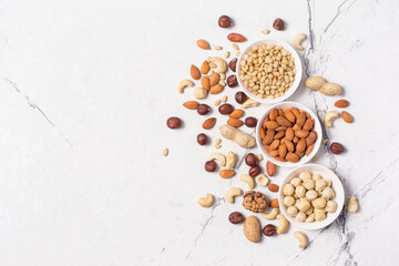 White bowls with nuts mix as snack or ingredient for tasty dessert, meal