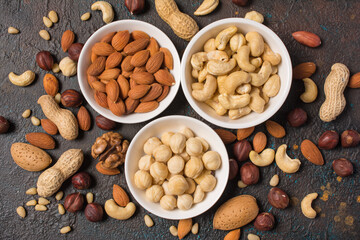 White bowls with nuts mix as snack or ingredient for tasty dessert, meal