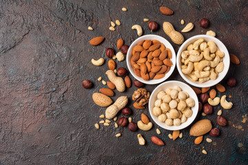 White bowls with nuts mix as snack or ingredient for tasty dessert, meal