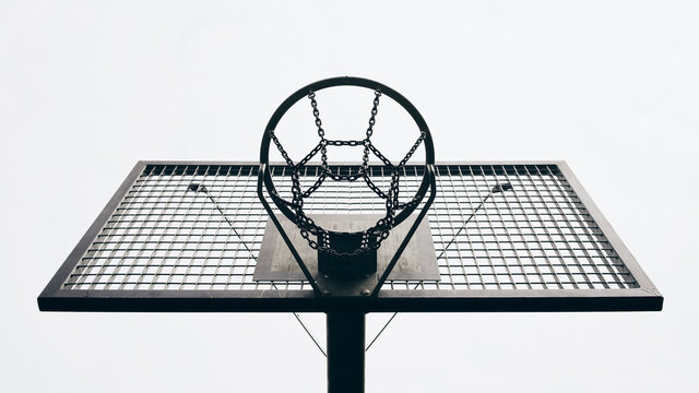 View from below metal basketball backboard and hoop
