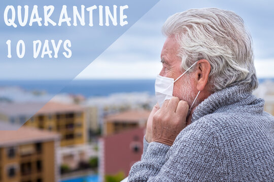 Old sad senior man with white hair and beard wearing surgical mask due to coronavirus stays in the balcony for self-isolation due to quarantine by coronavirus