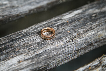 wedding rings on an old wooden bench 