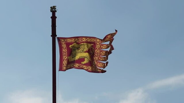 Venetian flag blowing in the wind, a symbol of a very strong identity and belonging, depicts a winged lion, symbol of the patron saint of the city and of the Serenissima Republic of Venice