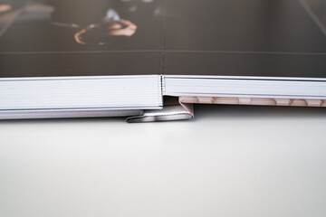 close up. photo book binding. storing photos from a photo session in a photobook. the result of the...