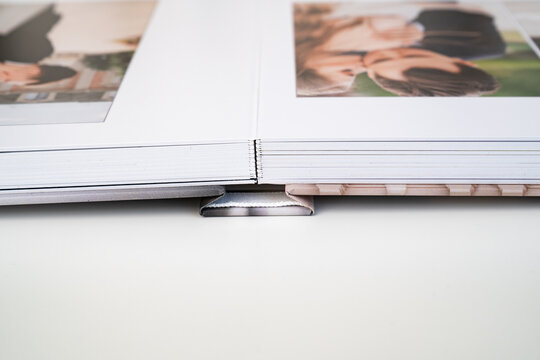 close up. photo book binding. storing photos from a photo session in a photobook. the result of the photographer and designer.