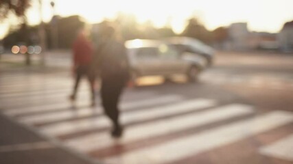 Blurry anonymous people crossing road in city - Powered by Adobe
