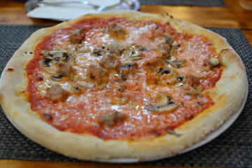 baked pizza at the table close up