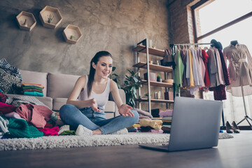 Full length photo of positive girl sit floor carpet legs crossed folded use laptop record fashion...