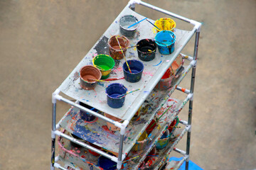 Artist paint brushes and palette on wooden background