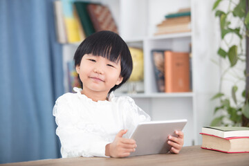 Kids using tablet for online lessons at home