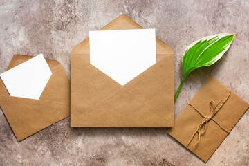 Blank cards mockup in envelope and green hosta leaf. Wedding invitation.Template for your design. Minimal stationery scene. Top view, flat lay, copy space.