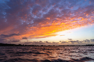 Beautifully lit clouds above the water of lake Zoetermeerse plas