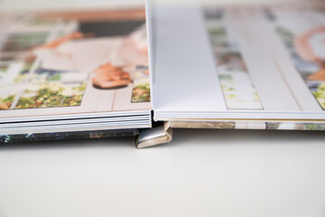 close up. photo book binding. storing photos from a photo session in a photobook. the result of the...