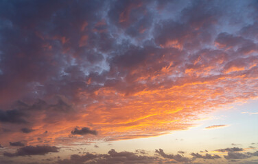 Fototapeta premium The setting sun turns threatening clouds into a splendor of color