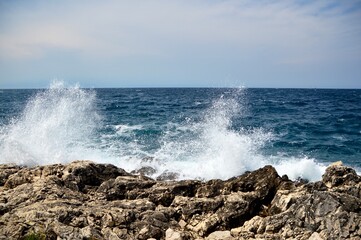 waves breaking against the rocks at the beach