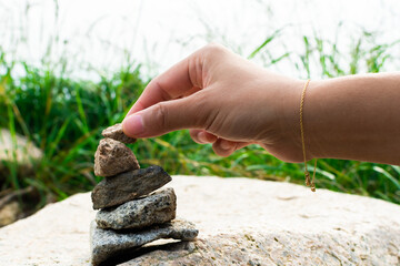 Adding a stone to a balanced stone stack at Bukhansan National Park. 
