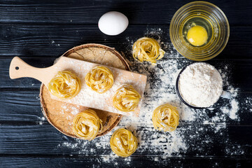 Tagliatelle cooking on a black table