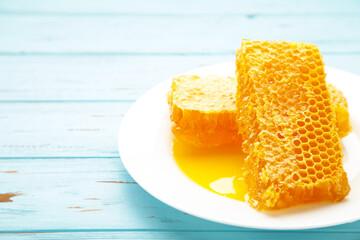 Sweet honeycomb on blue background. Top view