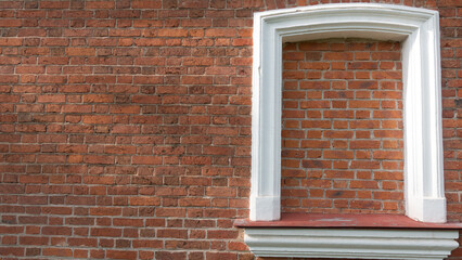 White frame on a brick wall.