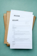 Vertical image.Top view of stack of resume forms and folders on the office blue desk
