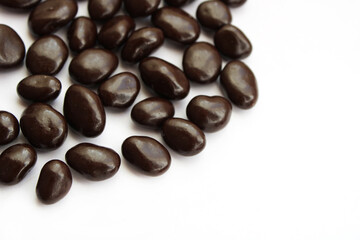 dark chocolate candies with nuts, white background