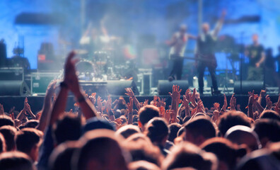 Crowd at concert - Cheering crowd in bright colorful stage lights