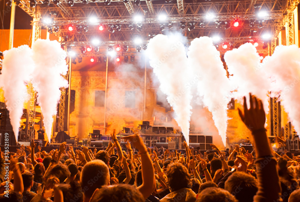 Wall mural crowd at concert - cheering crowd in bright colorful stage lights