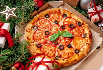 Christmas pizza margarita with Christmas decorations, gifts, spruce, toys