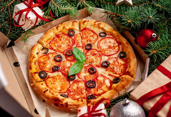 Christmas pizza margarita with Christmas decorations, gifts, spruce, toys
