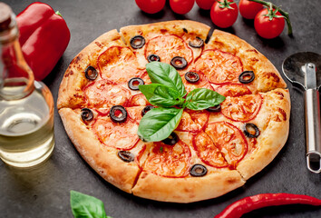 pizza margarita with basil on a stone background