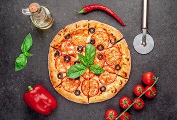 pizza margarita with basil on a stone background